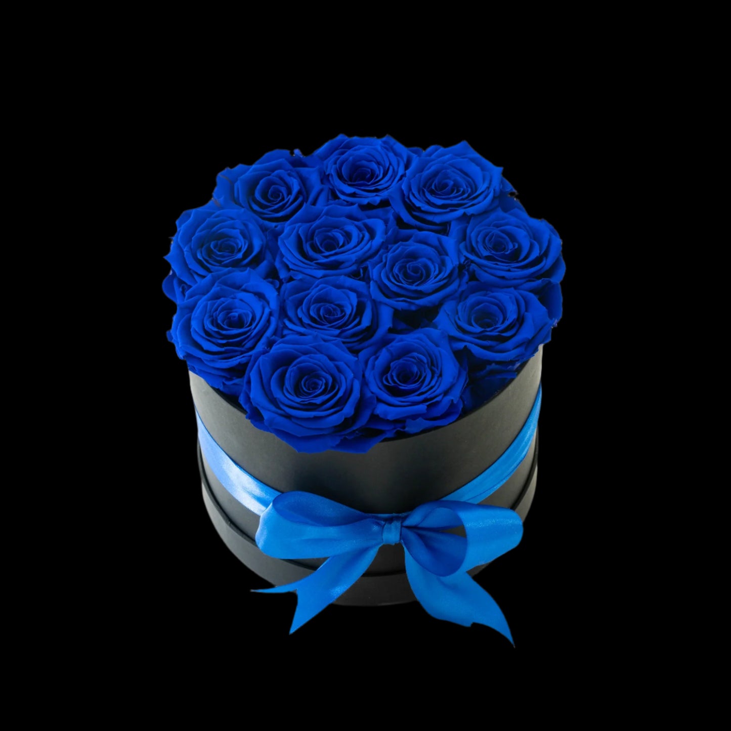 Black box with blue roses and a blue bow on a white background