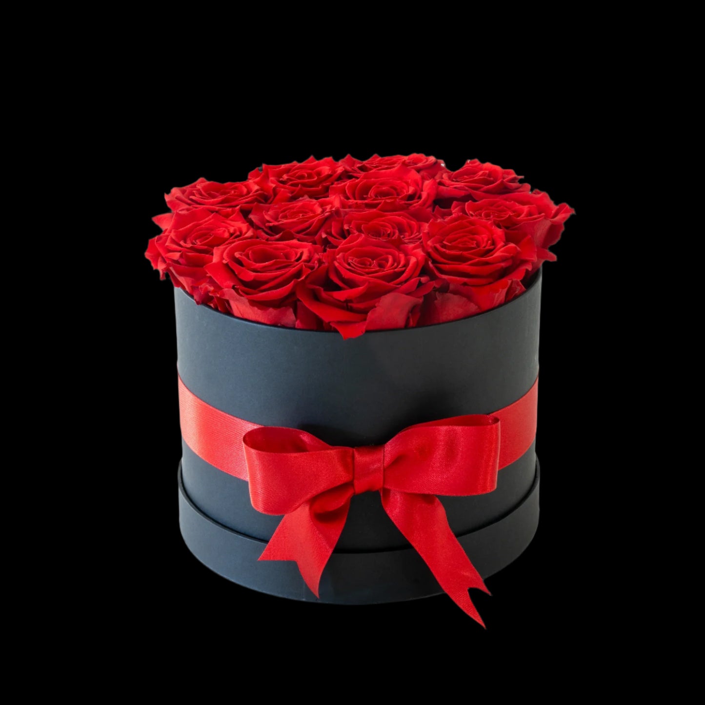 Black box with red roses and a red ribbon on a white background