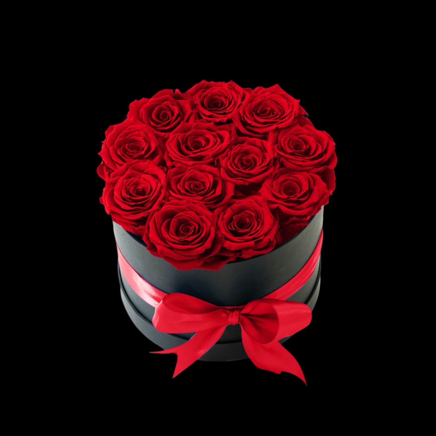 Black box with red roses and a red ribbon on a white background