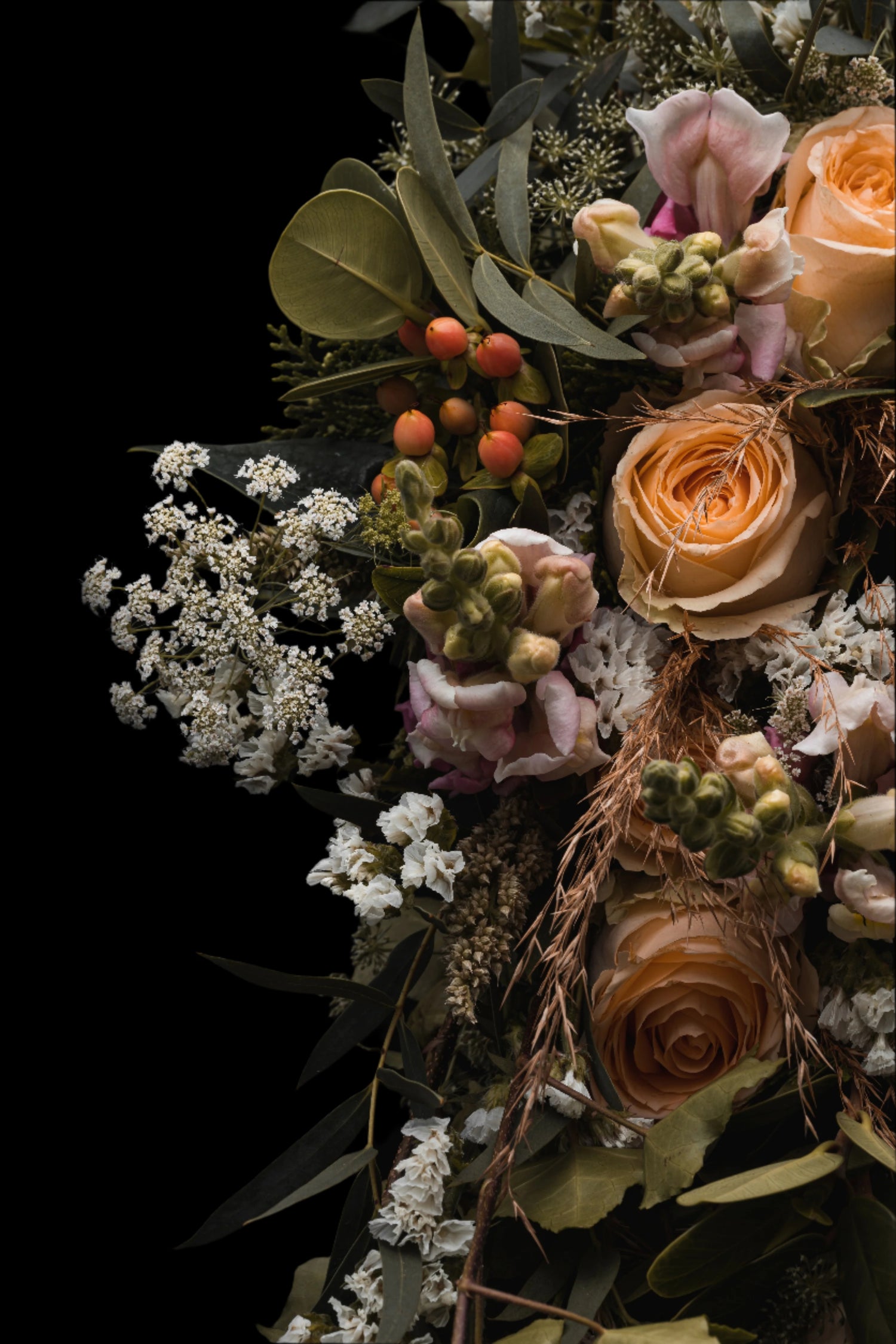 Bouquet of flowers with greenery on a dark background