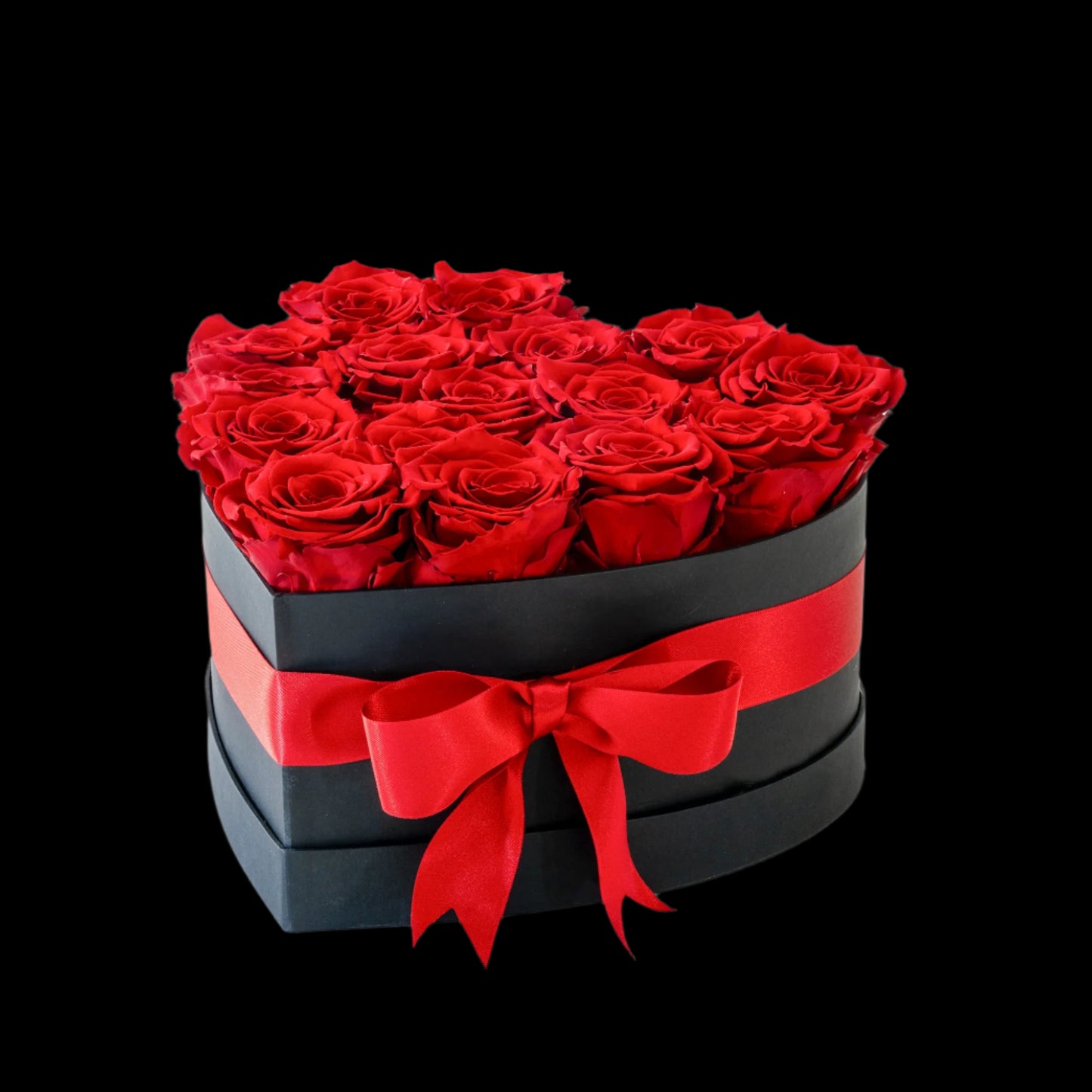 Heart-shaped box of red roses with a red ribbon on a white background